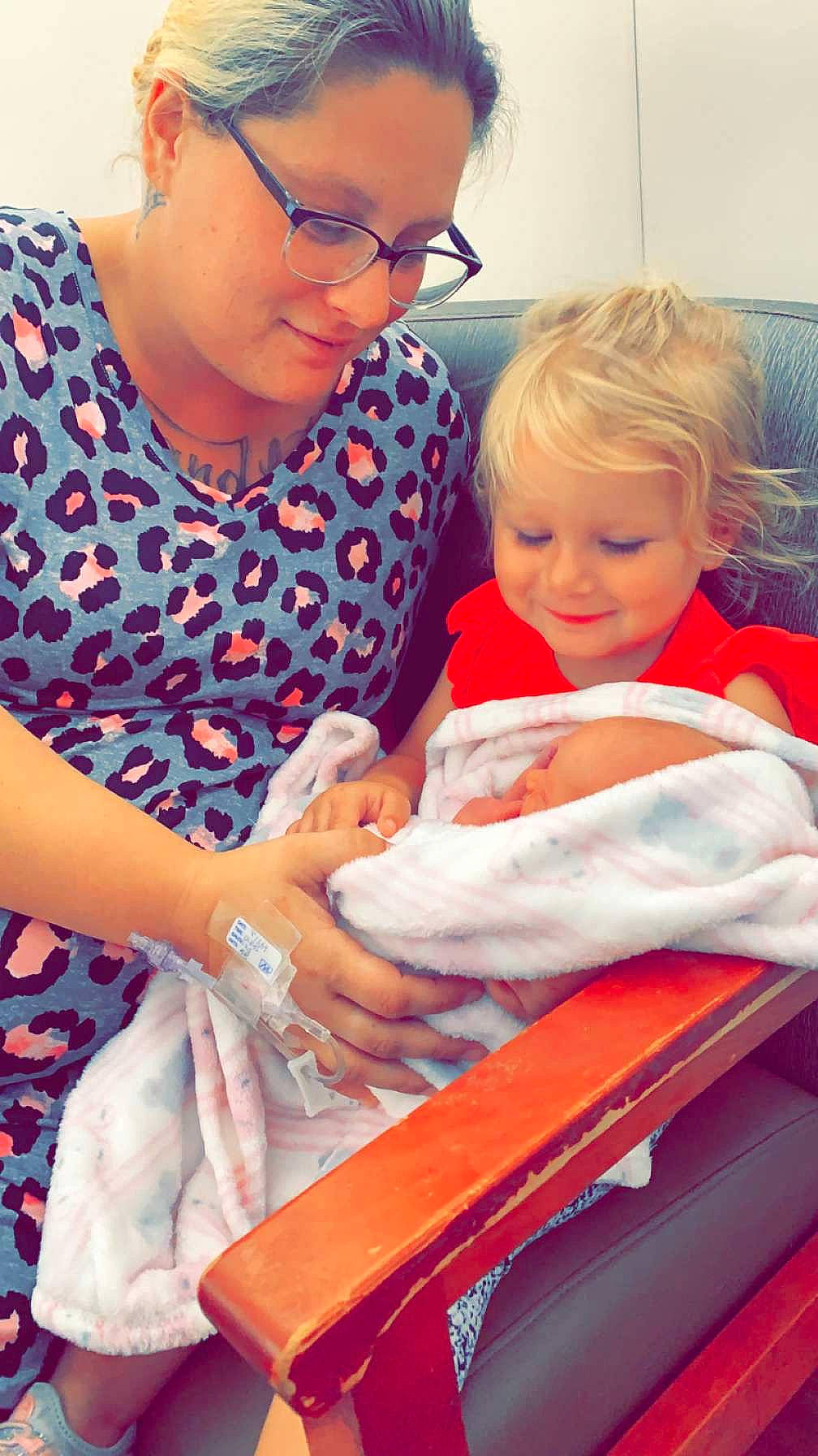 Annalice is registered to the contest to win money with this photo: baby, child, comfort, event, eyewear, face, finger, fun, gesture, glasses, happy, human_body, interaction, joy, lap, organ, person, service, sitting, skin