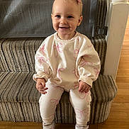 Thea joined the competition — help win amazing prizes! toddler, child, smiling, sitting, stairs, carpet, pink_bow, white_outfit, pink_bows_pattern, sneakers, wooden_floor, railing, indoor, happy, person, young_child, casual_clothing, portrait, cute, home