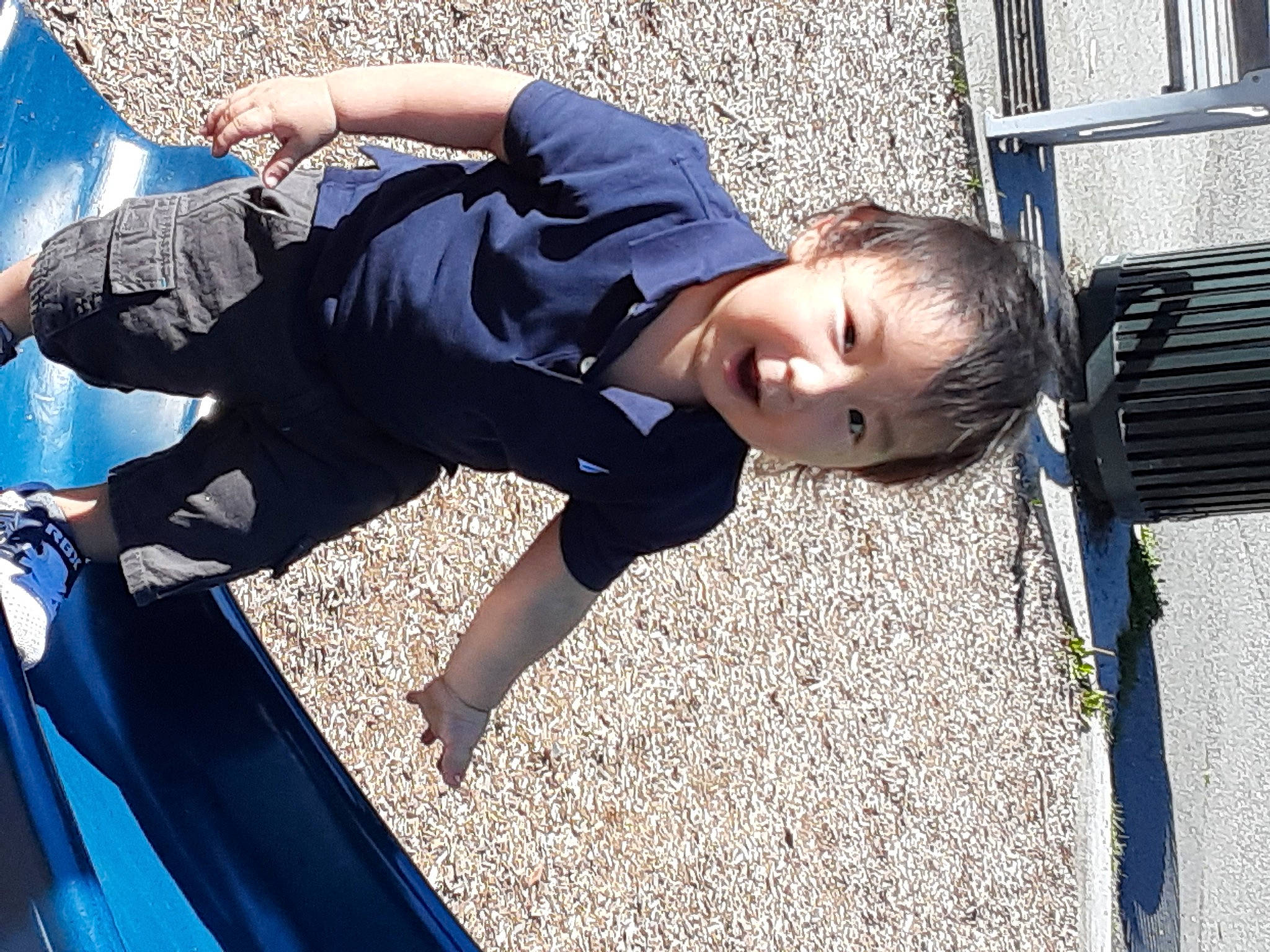 Preston is registered to the contest to win money with this photo: automotive_exterior, blue, child, comfort, denim, elbow, electric_blue, fun, grass, leisure, person, sitting, smile, t_shirt, toddler, tree, vacation, wood