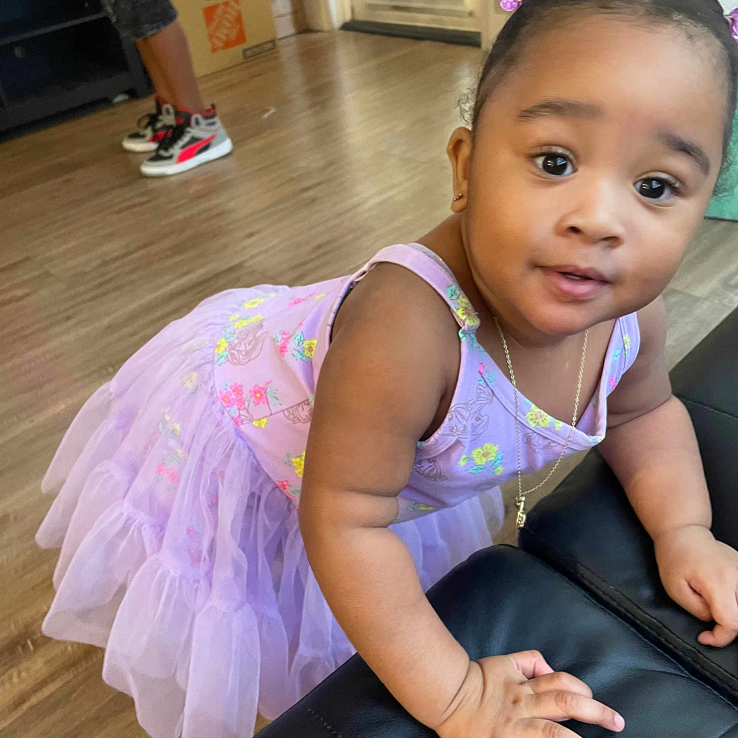 Alainna joined the competition — help win amazing prizes! child, toddler, girl, portrait, smiling, indoors, dress, lavender, princess_dress, hair_bows, earrings, necklace, sitting, crawling, ottoman, leather_furniture, wood_floor, window_blinds, sneakers, home