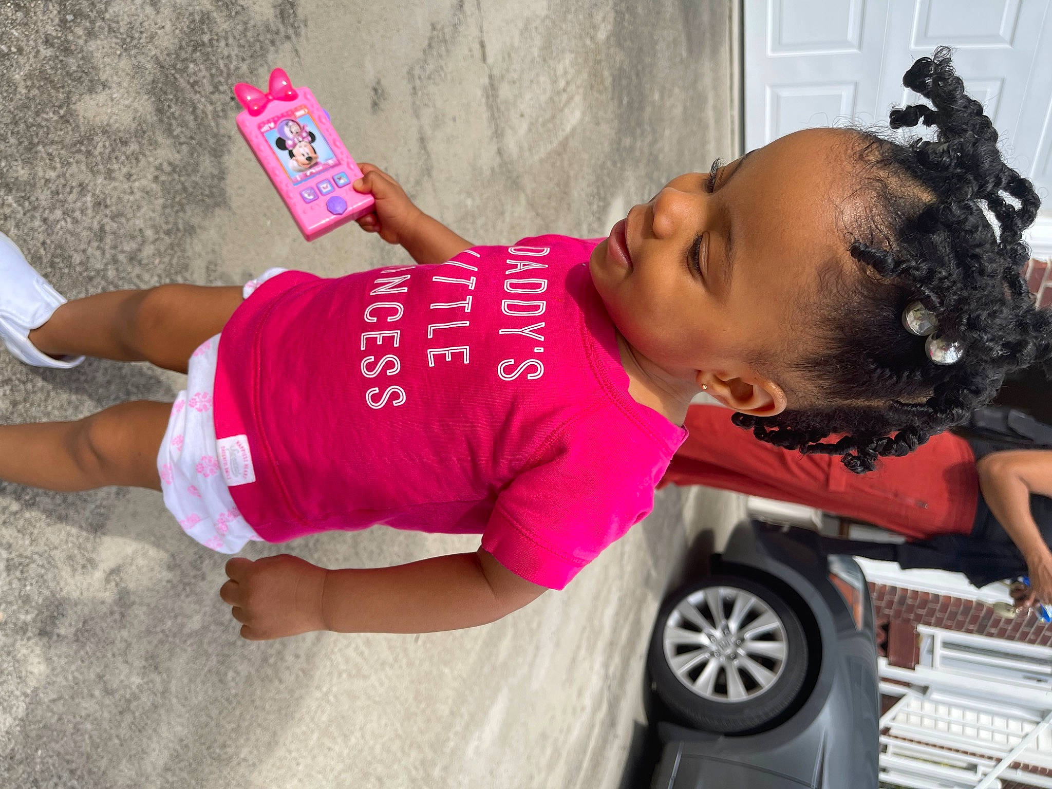 Taylani is registered to the contest to win money with this photo: automotive_design, automotive_tire, car, child, fashion_accessory, fun, hat, human_leg, magenta, person, pink, shorts, street, street_fashion, t_shirt, thigh, tire, trunk, vehicle_door, waist