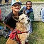 Bruce Le Roy is registered to the contest to win money with this photo: boots, casual_clothing, child, curious, daylight, dog, friendship, grass, group, happy, harness, hat, leash, nature, outdoor, park, people, playful, sitting, smiling