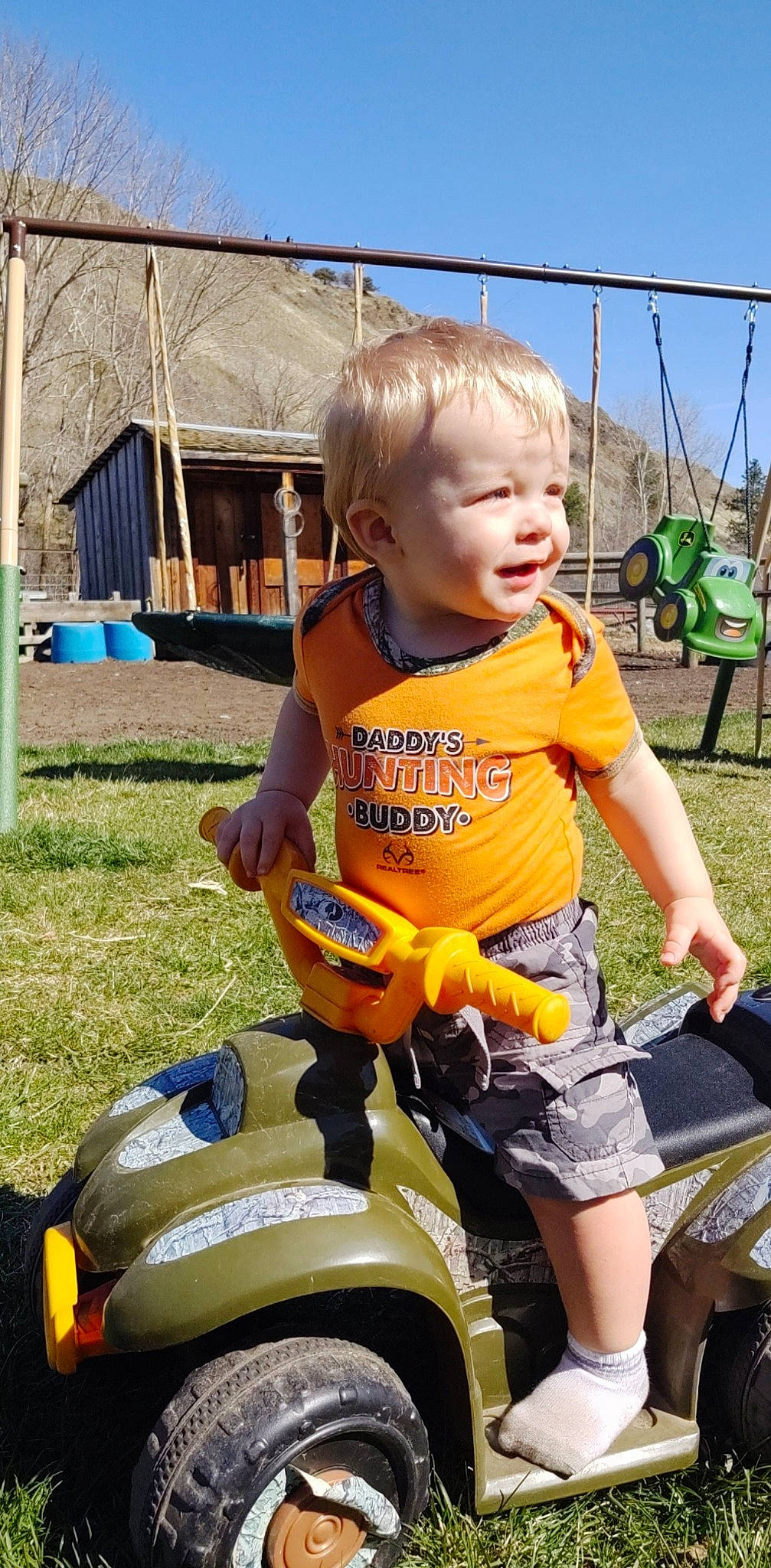 Kolton is registered to the contest to win money with this photo: child, fun, person, play, playground, public_space, riding_toy, smile, toddler, vehicle