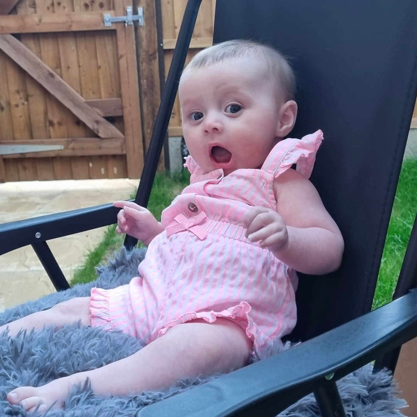 Willow Read joined the competition — help win amazing prizes! baby, backyard, barefoot, casual, chair, child, cushion, daylight, expression, fence, fluffy, grass, infant, outdoor, person, pink_outfit, seat, summer_clothes, surprised, wooden_fence