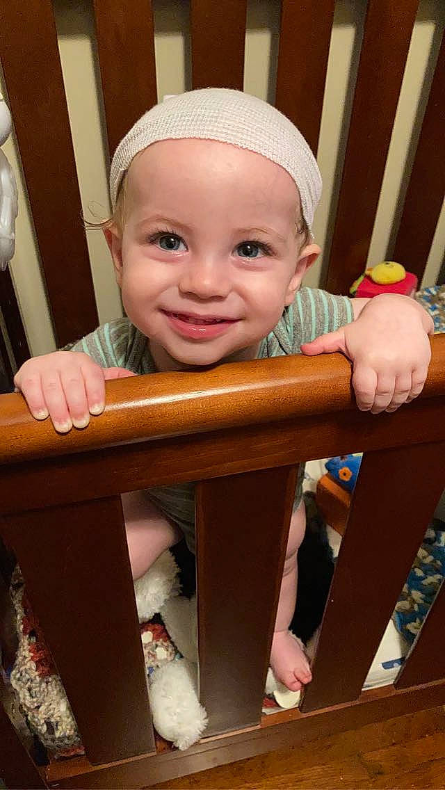 Sly is registered to the contest to win money with this photo: baby, baby_safety, baby_toddler_clothing, beauty, cheek, child, finger, happy, headgear, infant_bed, joy, organ, people, person, product, skin, sleeve, smile, standing, thumb