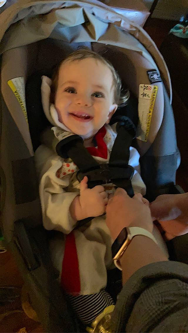 Sly is registered to the contest to win money with this photo: auto_part, automotive_design, baby, baby_carriage, baby_in_car_seat, baby_products, car_seat, car_seat_cover, child, comfort, event, fun, gesture, happy, head_restraint, joy, person, personal_protective_equipment, seat_belt, smile