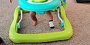 Elijah is registered to the contest to win money with this photo: baby, walker, carpet, smile, indoor, television, person, toy, footwear, sock, clothing, screen, entertainment, child, happy, living_room, furniture, technology, background, floor