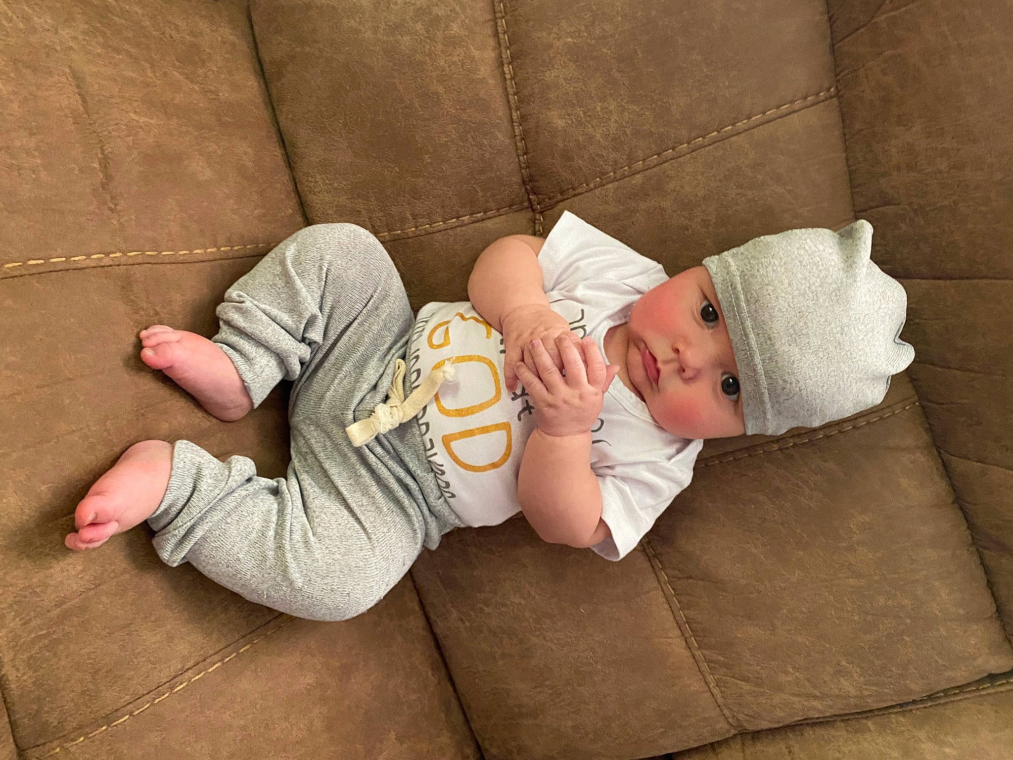 Weslan joined the competition — help win amazing prizes! baby, baby_sleeping, baby_toddler_clothing, child, comfort, finger, flooring, foot, hardwood, hat, headwear, human_leg, knee, leg, linens, mammal, person, sitting, skin, sock