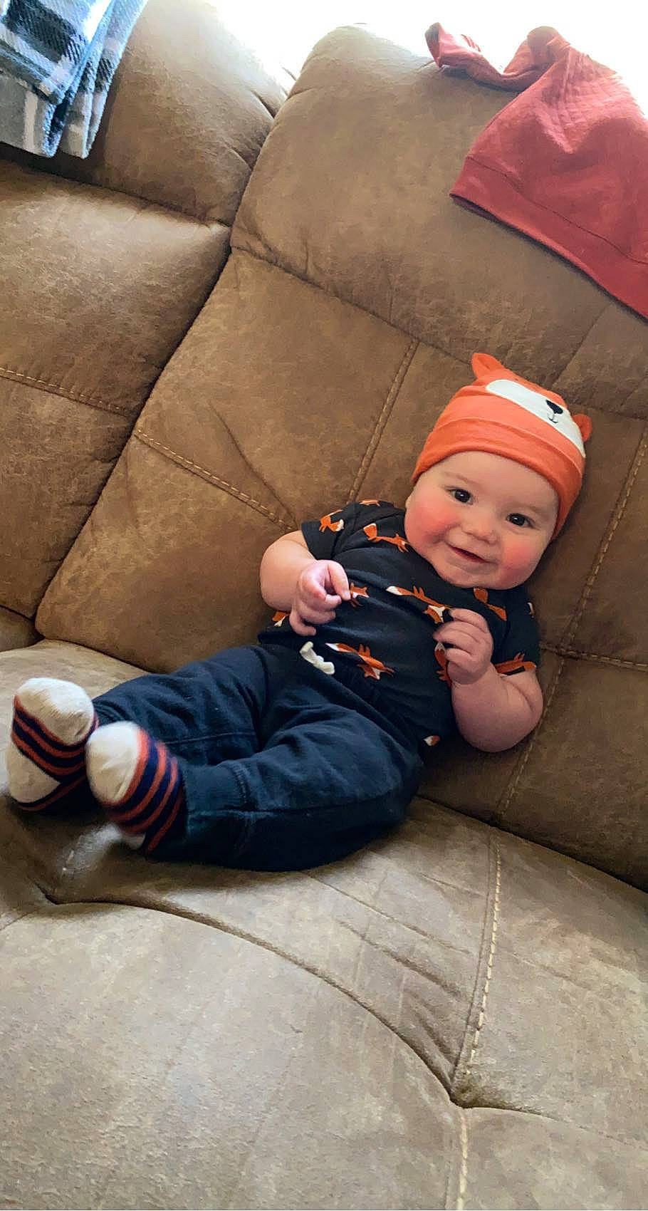 Weslan joined the competition — help win amazing prizes! baby, baby_toddler_clothing, cap, child, comfort, couch, finger, flooring, fun, headwear, human_body, human_leg, joy, knee, lap, mouth, person, plant, sitting, smile