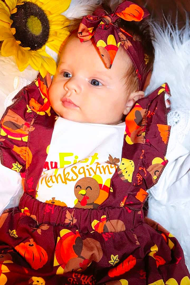 Mavis joined the competition — help win amazing prizes! baby, baby_toddler_clothing, cheek, child, event, eye, flower, fun, happy, iris, orange, pattern, person, petal, pink, red, sleeve, sunflower, toddler