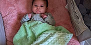 Arielle joined the competition — help win amazing prizes! baby, infant, blanket, pink, green, face, cushion, playpen, soft, clothing, cute, lying_down, indoors, comfort, child, infant_face, fist, pattern, fabric, resting
