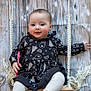 baby, child, swing, candy_cane, black_dress, holiday_pattern, wooden_background, rosy_cheeks, white_tights, festive, cute, indoor, portrait, smiling, holiday, winter, toy, rope, seat, happy