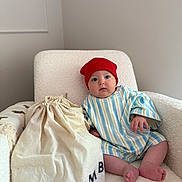 Abel Reign is registered to the contest to win money with this photo: baby, blanket, bodypart, bonnet, cap, chair, clothing, couch, cushion, face, finger, furniture, hat, head, homedecor, newborn, person, photography, portrait, sitting