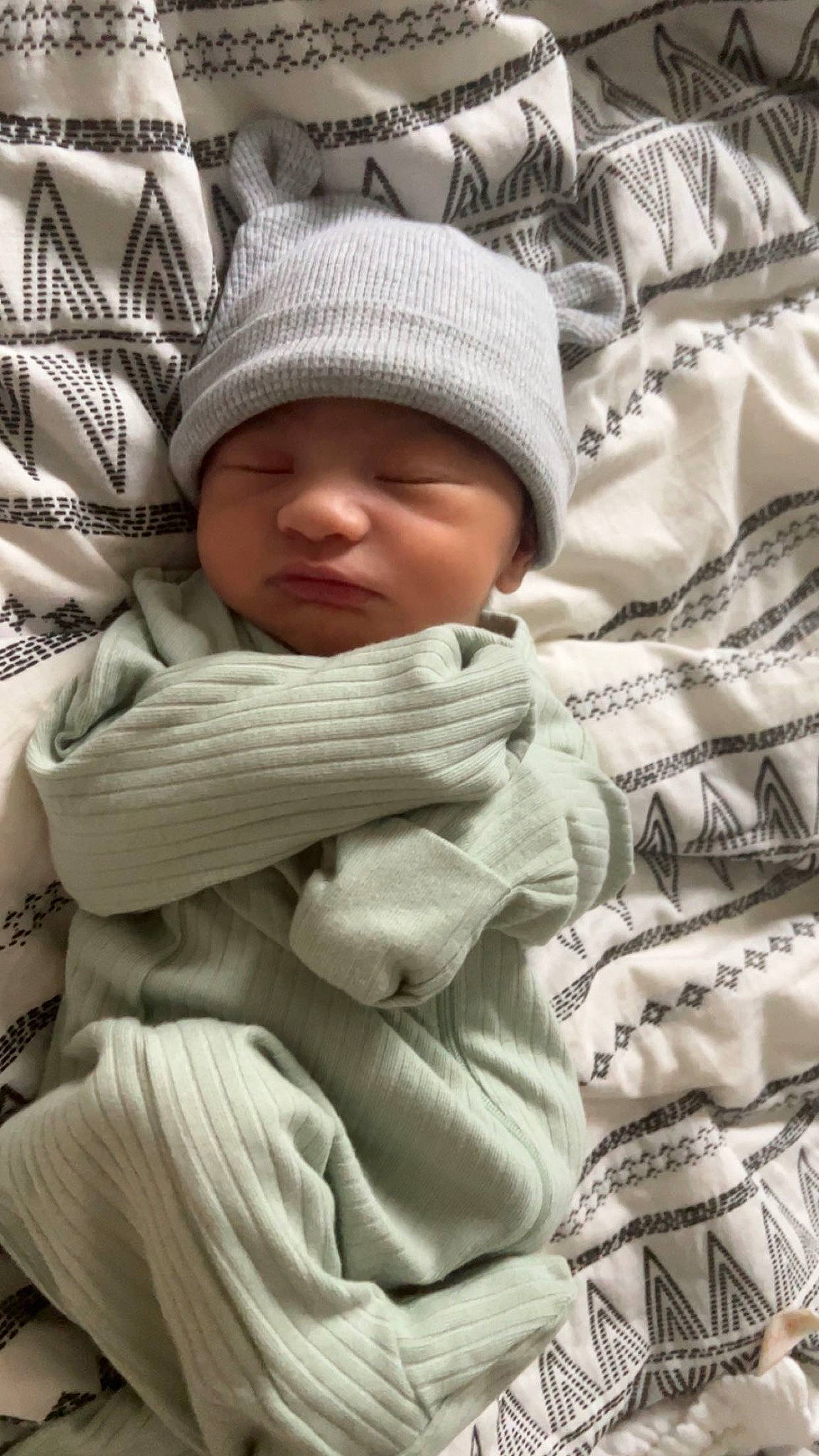 Andreas is registered to the contest to win money with this photo: baby, baby_sleeping, bedding, cap, child, comfort, fur, headgear, headwear, knit_cap, linens, pattern, person, sitting, skin, sleeve, textile, toddler, white, winter