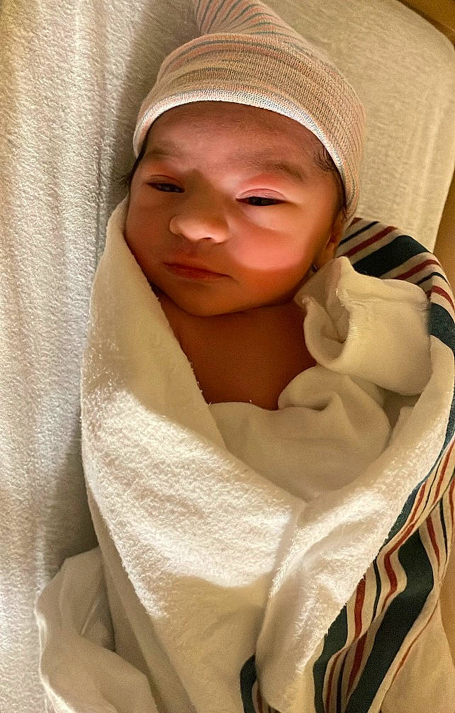 Andreas is registered to the contest to win money with this photo: baby, baby_products, baby_toddler_clothing, cap, cheek, child, comfort, eyebrow, fur, headwear, linens, outerwear, person, room, sleeve, smile, thumb, toddler, towel, wool