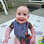 Grayson is registered to the contest to win money with this photo: baby, child, smiling, bib, outdoor, playmat, space_theme, planets, sun, moon, stars, toy, colorful, happy, sitting, cute, infant, clothing, face, hand
