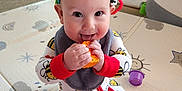 Grayson is registered to the contest to win money with this photo: baby, child, onesie, bee_pattern, toy, play_mat, colorful, happy, smiling, indoor, infant, chewing, ring_toy, orange_toy, sitting, home, floor, playtime, cute, playful