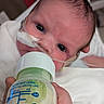 Ayden joined the competition — help win amazing prizes! newborn, baby, infant, child, face, eyes, bottle, feeding, milk, medical_tube, hospital, bedding, blanket, white_clothing, portrait, close_up, lying_down, caregiver_hand, indoors, photography