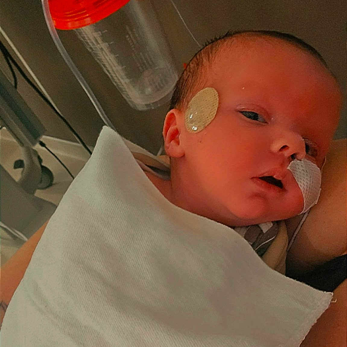 Ayden is registered to the contest to win money with this photo: newborn, baby, infant, child, portrait, sleepy, face, hospital, blanket, medical, sticker, tubing, swaddled, close_up, head, eyes, nose, mouth, caregiver, indoor