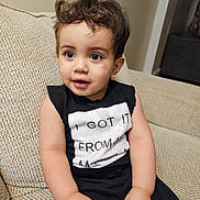 Adrian joined the competition — help win amazing prizes! black_shirt, casual, child, clothing, couch, curly_hair, cute, expression, eyes, face, furniture, hands, home, indoor, person, portrait, relaxed, sitting, toddler, young