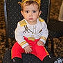toddler, child, crown, costume, chair, red_pants, black_booties, gold_details, indoor, portrait, serious_expression, seated, baby, young_child, cute, costume_party, face, person, fashion, closeup