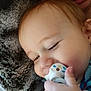Tristan is registered to the contest to win money with this photo: baby, pacifier, close_up, cuddling, blanket, fuzzy, face, hand, infant, child, comfort, indoor, person, skin, expression, resting, young, portrait, sleepy, cozy