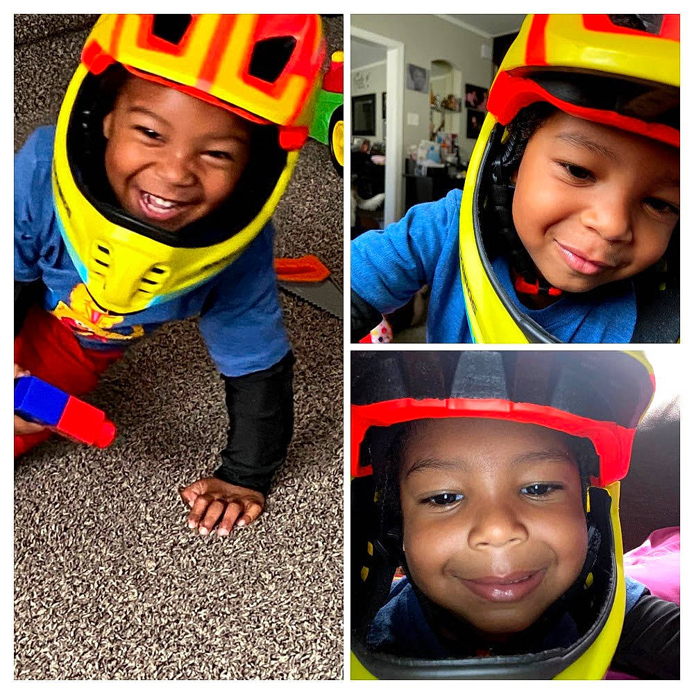 Landan is registered to the contest to win money with this photo: bicycle_helmet, black, cap, child, cool, face, facial_expression, happy, headgear, headwear, joy, nose, orange, outerwear, person, photograph, plant, product, selfie, sleeve