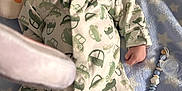 Theo joined the competition — help win amazing prizes! baby, sleeping, onesie, car_pattern, pillow, rainbow, blanket, star_pattern, pacifier, beaded_holder, toy, infant, cute, soft, cozy, hand, face, peaceful, indoors, resting