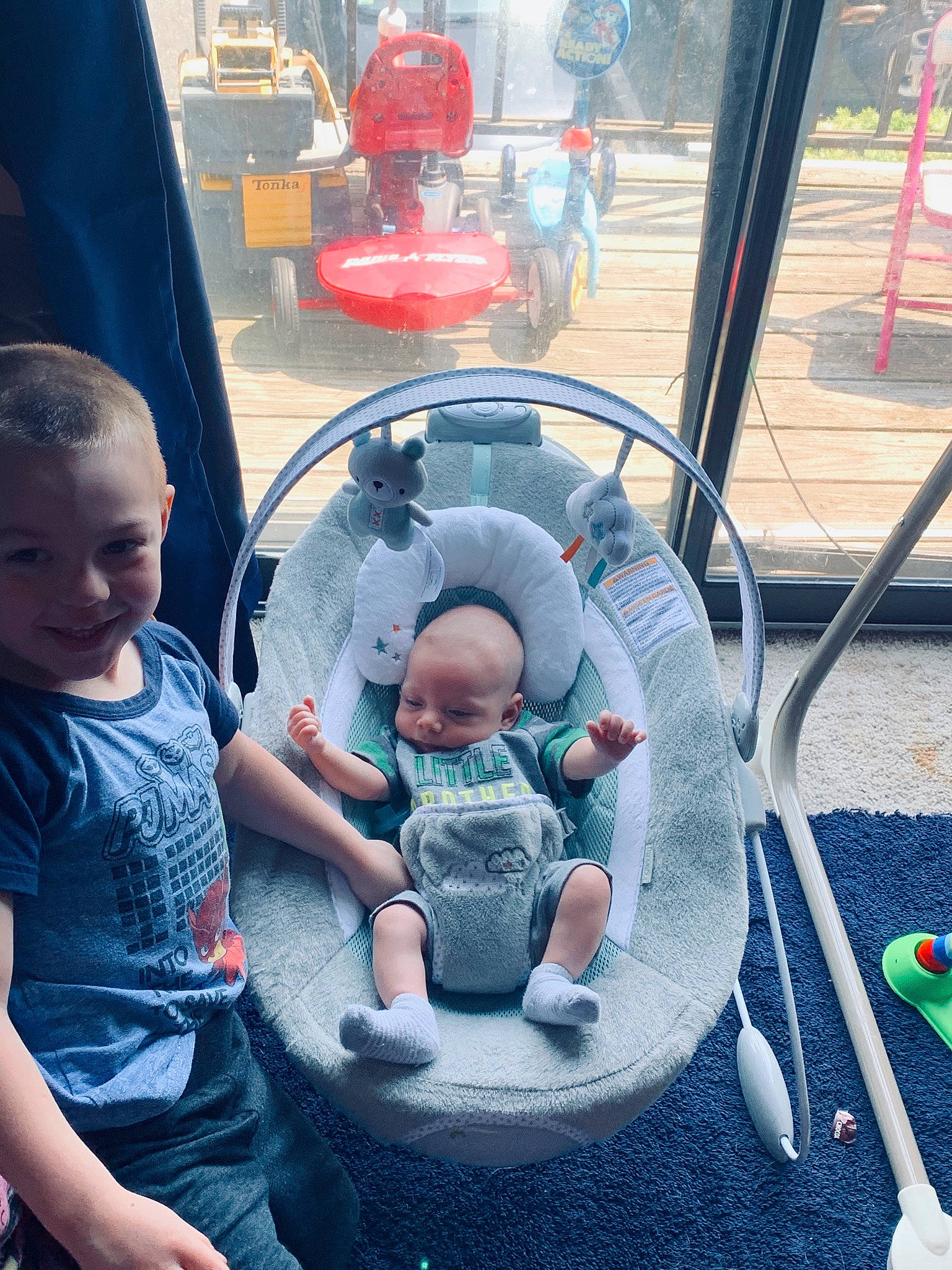 Kj is registered to the contest to win money with this photo: automotive_wheel_system, baby, baby_carriage, baby_products, baby_toddler_clothing, child, city, fun, happy, joy, leisure, motor_vehicle, outdoor_play_equipment, person, play, playground, public_space, recreation, sitting, smile