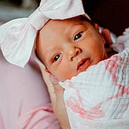Sara joined the competition — help win amazing prizes! baby, newborn, infant, headband, bow, blanket, wrapped, closeup, face, eyes, soft, pink, white, hand, cradle, skin, portrait, cute, young, person