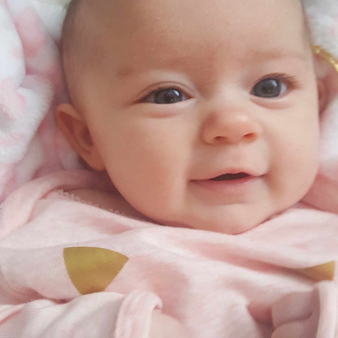 Briana joined the competition — help win amazing prizes! cheek, child, close_up, eye, face, girl, hand, head, infant, iris, lip, mouth, nose, person, pink, product, skin, smile, toddler