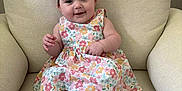 Elodie joined the competition — help win amazing prizes! baby, child, smiling, dress, headband, flower, pink, floral, chair, cushion, indoors, cute, happy, infant, skin, person, sitting, foot, hand, portrait