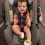Elodie joined the competition — help win amazing prizes! baby, child, car_seat, smiling, pink_onesie, headband, crocheted_booties, flowers, happy, blue_eyes, straps, indoor, flooring, baby_accessory, comfort, cute, infant, seat, safety, portrait