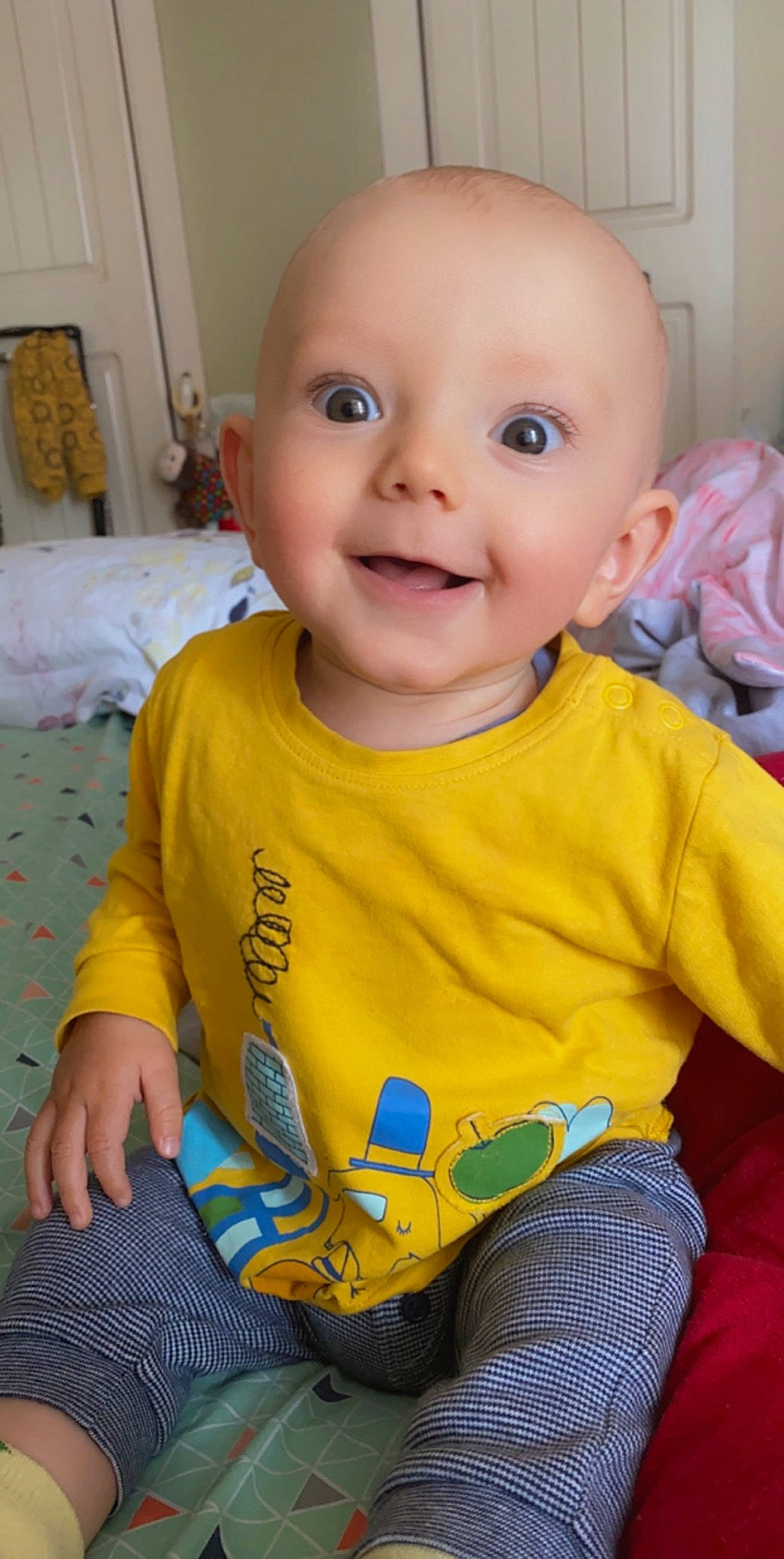 Marco is registered to the contest to win money with this photo: baby, baby_products, baby_toddler_clothing, cheek, child, face, iris, joy, person, sitting, skin, smile, t_shirt, toddler, yellow