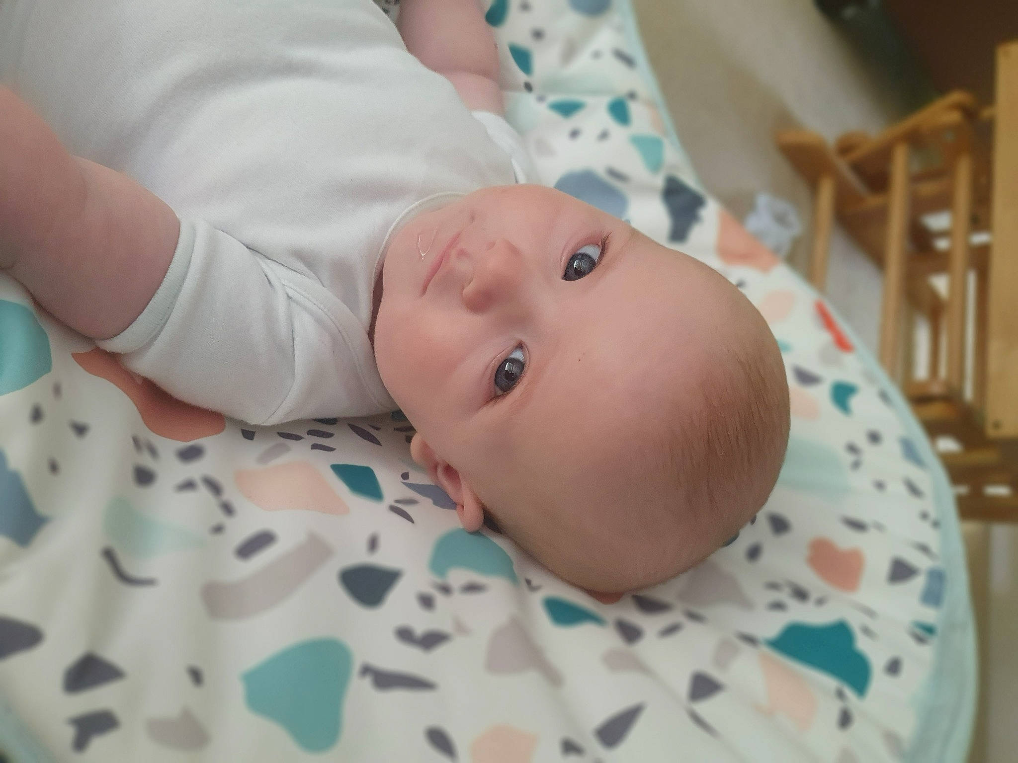 Freddie is registered to the contest to win money with this photo: baby, baby_products, baby_safety, baby_toddler_clothing, cheek, child, comfort, eye, iris, linens, pattern, person, room, toddler