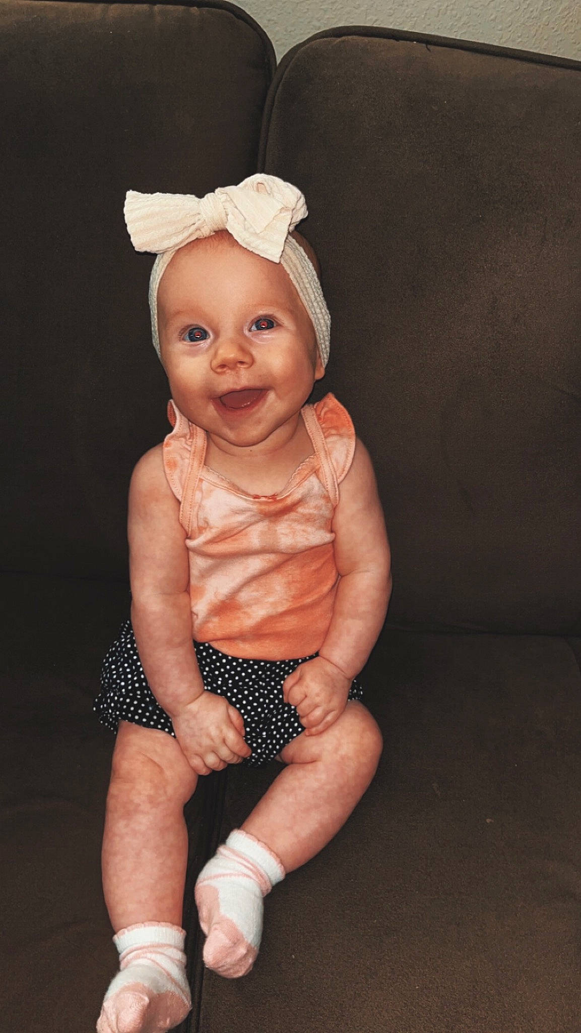 Ivey Jean is registered to the contest to win money with this photo: abdomen, baby, baby_toddler_clothing, chest, child, costume_accessory, face, fashion_accessory, foot, human_leg, joy, knee, leg, person, sitting, sleeve, smile, thigh, thumb, toddler