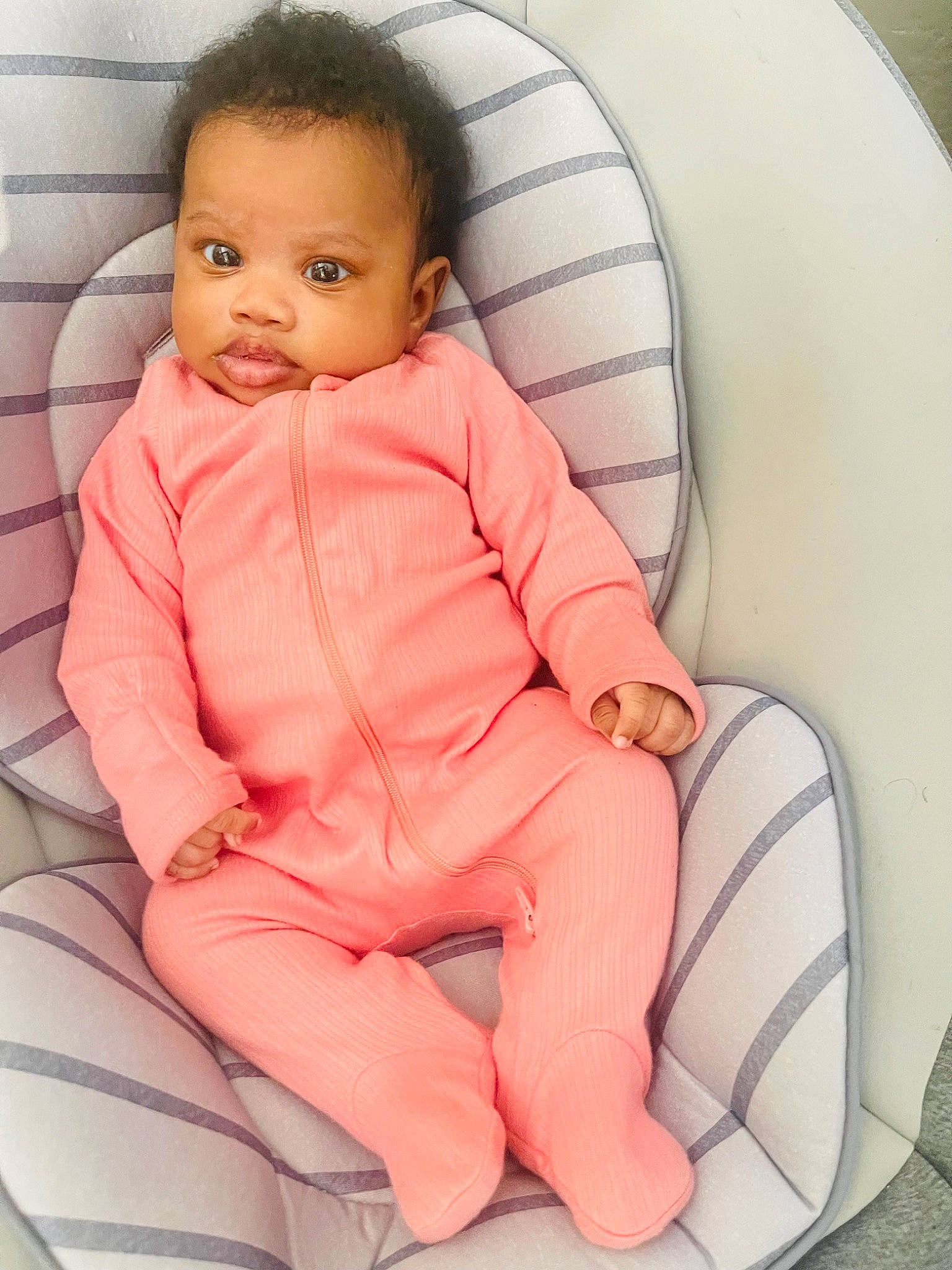 Nova is registered to the contest to win money with this photo: arm, baby, baby_products, baby_toddler_clothing, car_seat, carmine, chair, cheek, child, comfort, face, finger, head, person, sitting, skin, sleeve, toddler