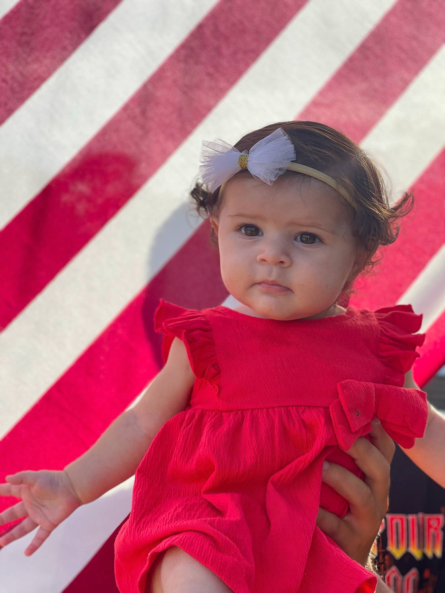 Isabell is registered to the contest to win money with this photo: baby_toddler_clothing, beauty, child, day_dress, dress, facial_expression, fun, hairstyle, happy, head, headwear, human_leg, magenta, one_piece_garment, person, pink, recreation, red, skin, thigh