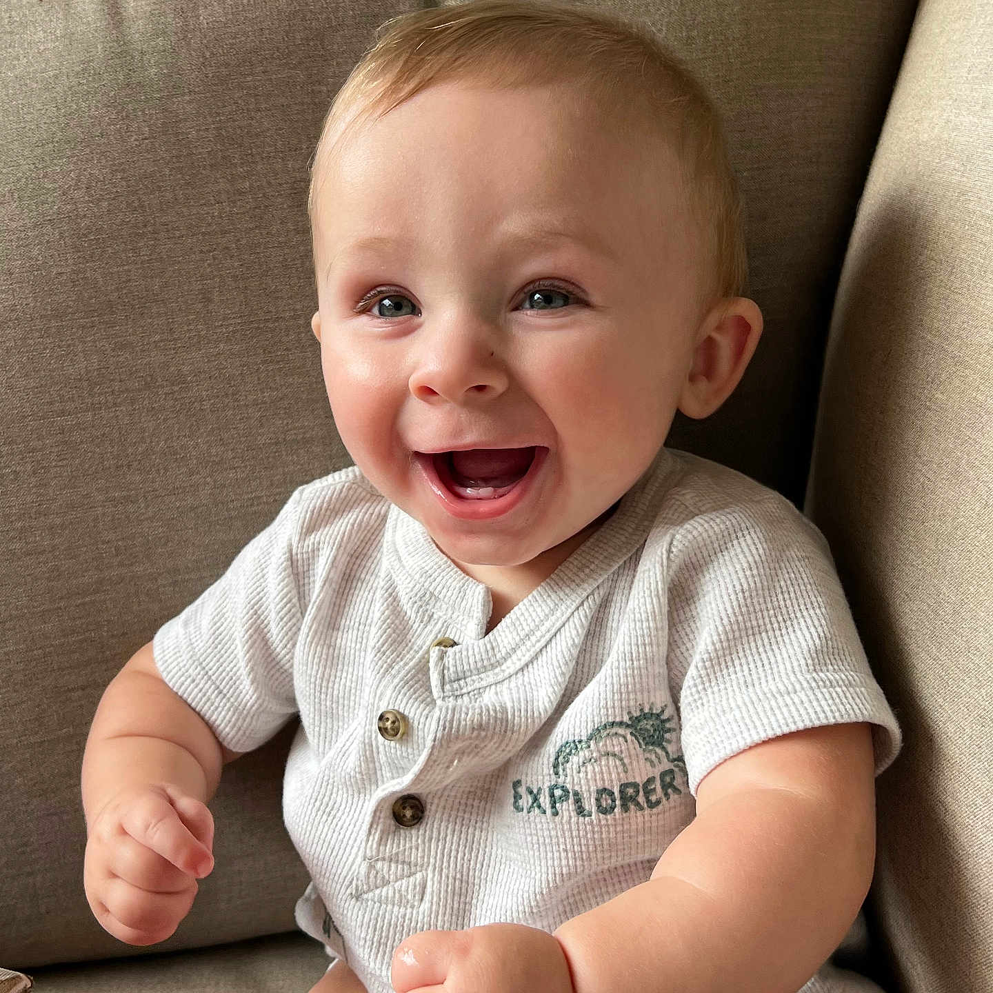 Dewayne is registered to the contest to win money with this photo: baby, smiling, happy, child, infant, couch, indoor, clothing, short_sleeve, sitting, face, cute, person, light_skin, portrait, young_child, explorer, buttoned_shirt, human, baby_girl