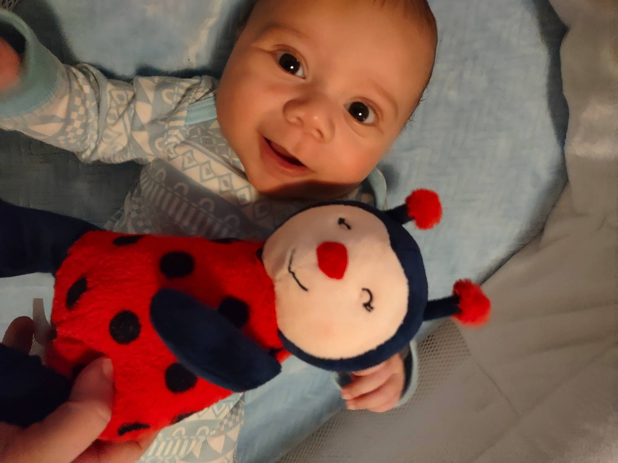 Marcus is registered to the contest to win money with this photo: baby, baby_products, baby_toddler_clothing, cheek, child, comfort, finger, happy, head, linens, mouth, nose, orange, person, skin, sleeve, smile, textile, thumb, toddler