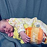 Kallie is registered to the contest to win money with this photo: baby, sleeping, plush_toy, winnie_the_pooh, blanket, pajamas, cozy, infant, child, cute, peaceful, hand, face, soft_toy, resting, indoors, comfortable, floral_pattern, blue, pink