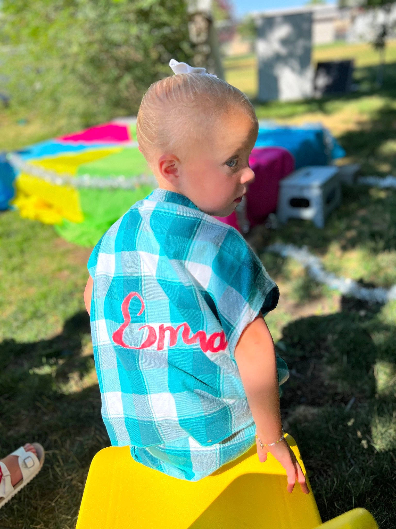 Emma is registered to the contest to win money with this photo: child, city, electric_blue, fun, grass, happy, lawn, leisure, outdoor_play_equipment, pattern, person, plant, play, recreation, shorts, sitting, sleeve, summer, t_shirt, toddler