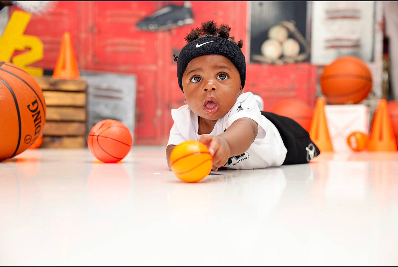 Camryn is registered to the contest to win money with this photo: ball, ball_game, basketball, competition_event, flooring, fun, games, happy, headwear, leisure, musical_instrument, orange, person, play, player, room, sports, sports_equipment, sports_gear, surprise