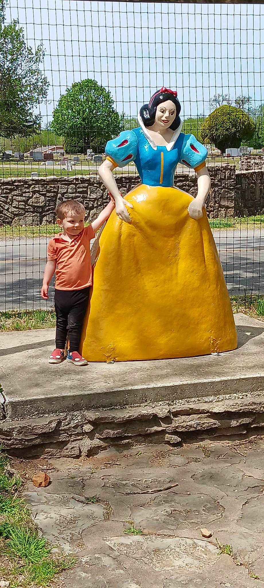 Harvey is registered to the contest to win money with this photo: asphalt, child, city, dress, fence, fun, happy, leg, leisure, person, plant, public_space, recreation, shorts, sky, soil, t_shirt, toddler, tourism, travel