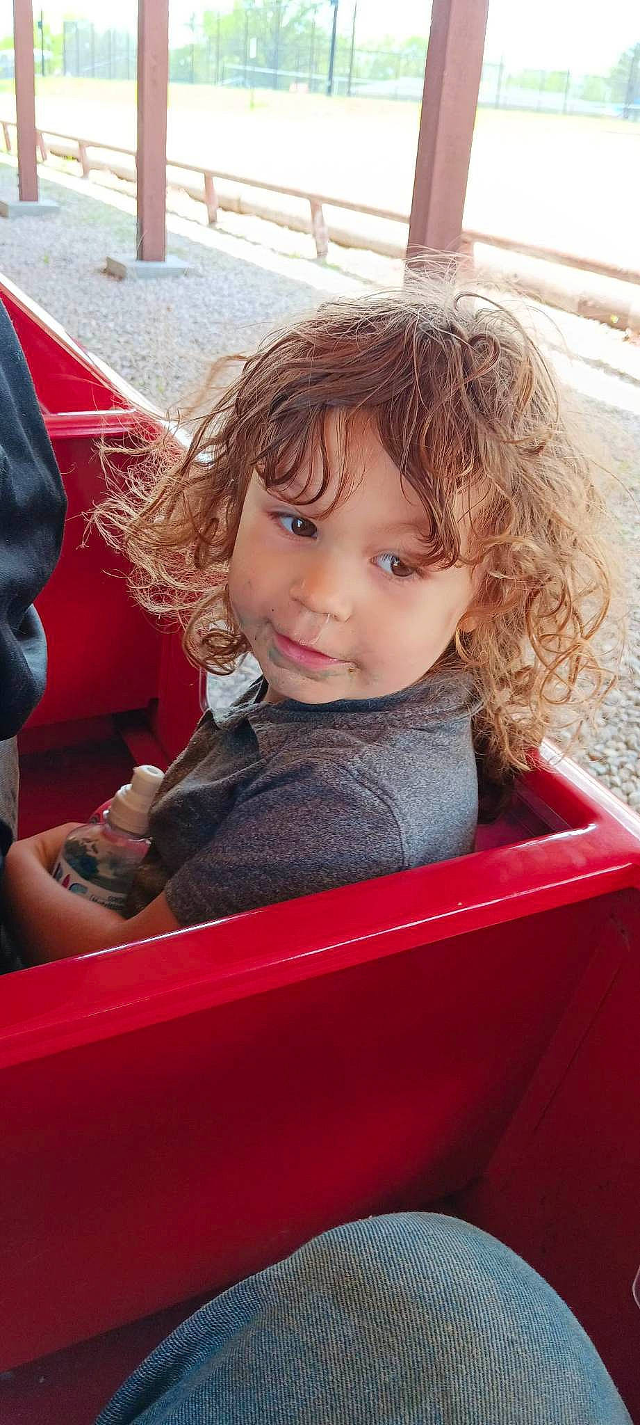 Rebekah joined the competition — help win amazing prizes! bangs, blond, brown_hair, child, chin, city, fun, grass, hair, happy, leisure, mouth, outdoor_play_equipment, person, play, recreation, sitting, skin, toddler, travel