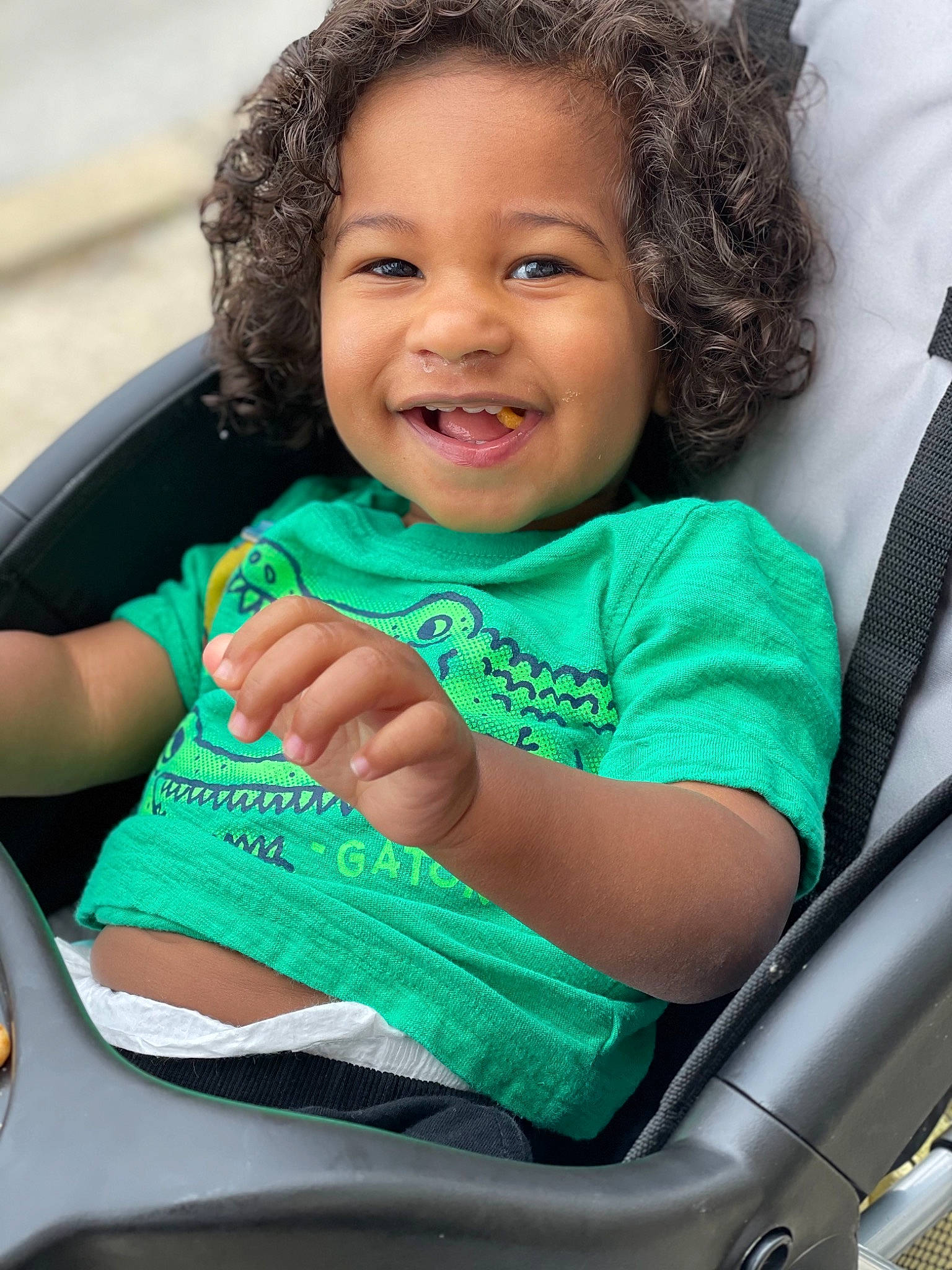 Camryn is registered to the contest to win money with this photo: arm, automotive_design, automotive_mirror, baby_carriage, black, child, eye, face, facial_expression, hairstyle, happy, human, joy, motor_vehicle, organ, person, product, skin, smile, steering_wheel