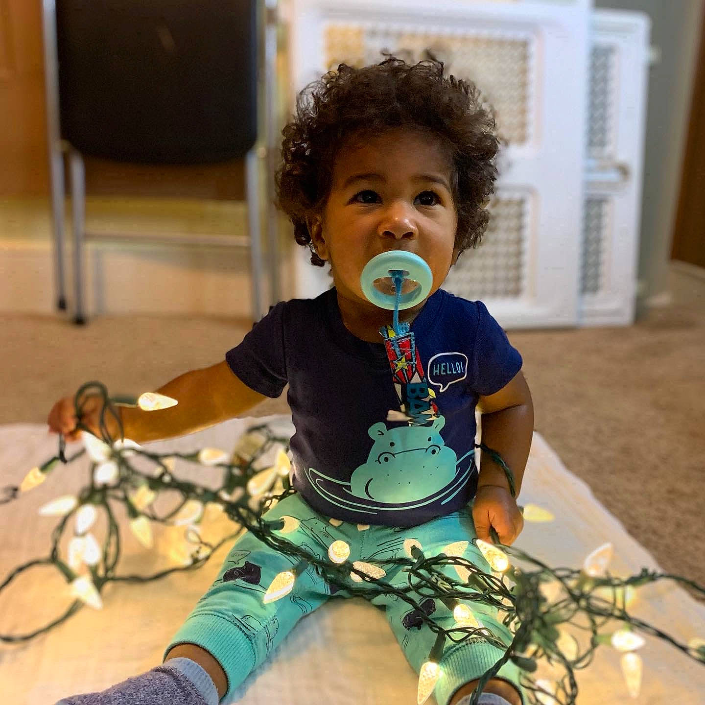 Camryn is registered to the contest to win money with this photo: audio_equipment, baby, baby_toddler_clothing, chair, child, entertainment, eyewear, fun, happy, head, jewellery, knee, performing_arts, person, play, sitting, skin, sleeve, t_shirt, thigh