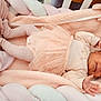 baby, blanket, clothing, crib, furniture, hosiery, infantbed, person, sock