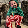 baby, child, infant, pacifier, costume, elf, green_hoodie, striped_pants, red_and_white, black_booties, blanket, soft_texture, indoors, cute, portrait, smiling, face, cozy, holiday, festive