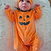 Matthew a rejoint le concours — aidez-le/la à gagner de superbes lots ! baby, infant, orange_outfit, pumpkin_costume, hat, blanket, lying_down, cute, child, portrait, indoors, soft_texture, holiday, halloween, clothing, person, face, expression, young_child, cozy